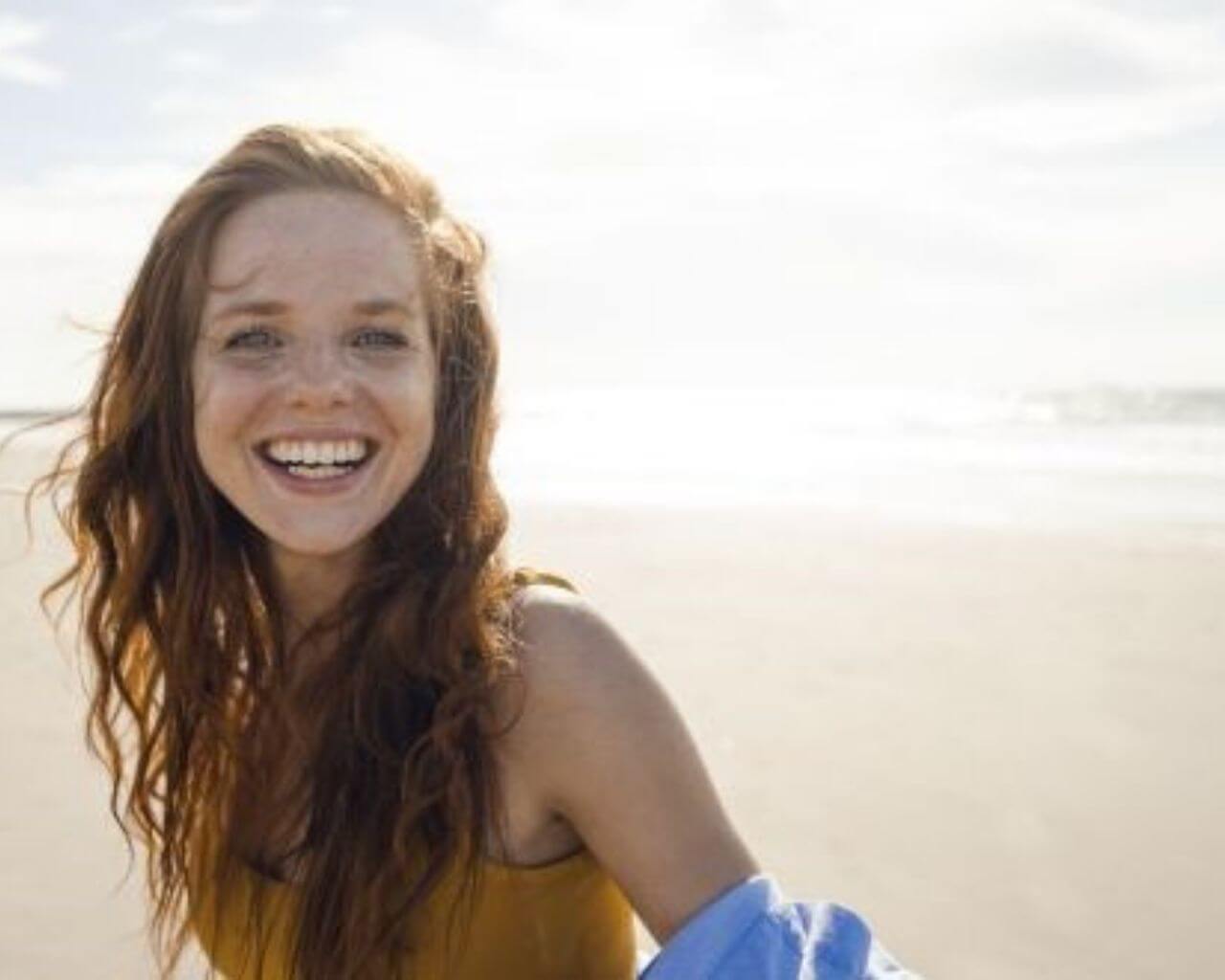pic of a smiling girl on a beach